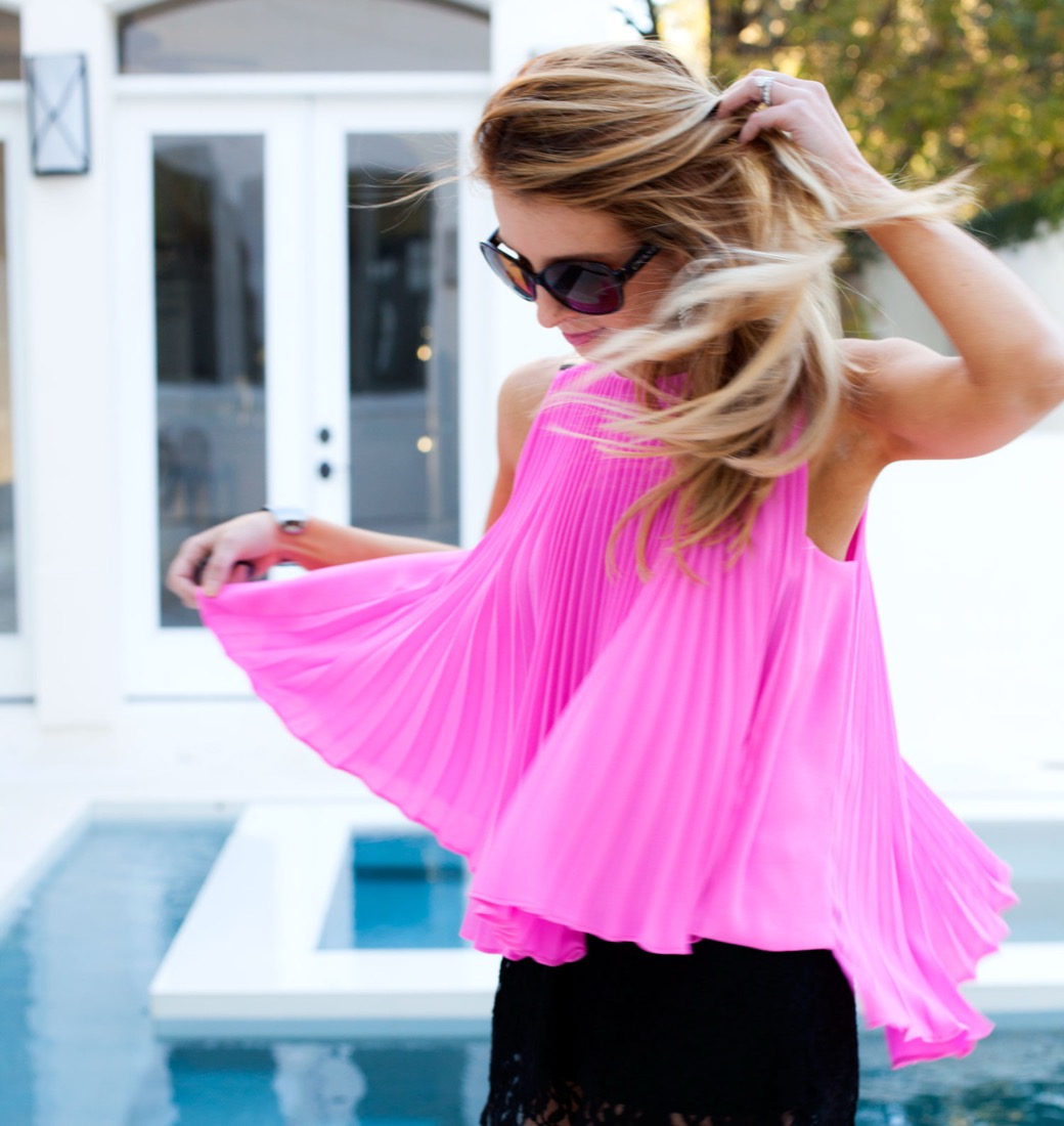 Katy in a hot pink pleated top by the pool