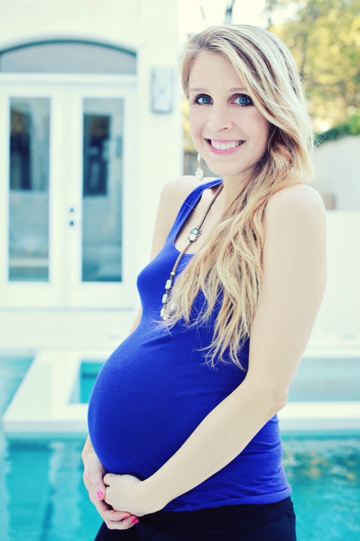 Katy, thirty-four weeks pregnant, by the pool